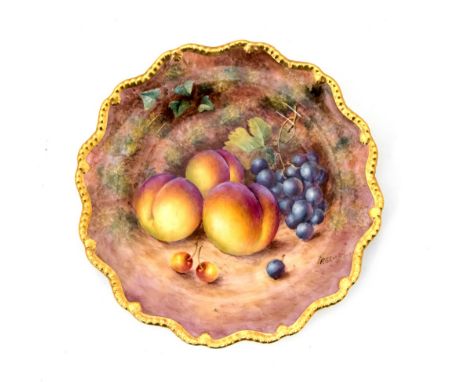 A Royal Worcester fruit painted plate, wavy gadrooned border, the centre painted by Freeman with grapes and peaches, 22.5cm d