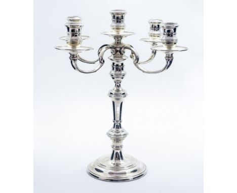 An Elizabeth II silver five light candelabrum, in the early 18th century style, the turned knopped baluster support with four