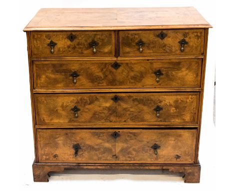 A George I style walnut chest of drawers, comprising two short over three long graduated drawers, the drawer fronts with book