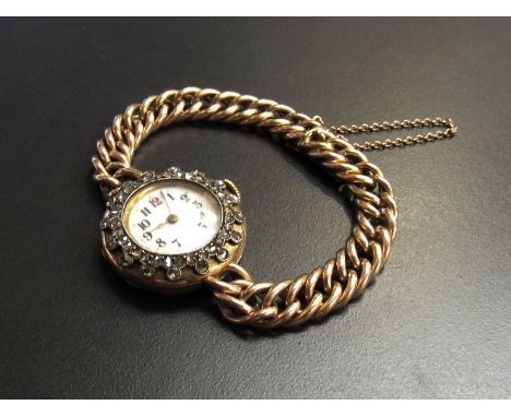 A lady's 15ct gold wristwatch the enamel face framed by old mine cut diamonds on heavy chain strap