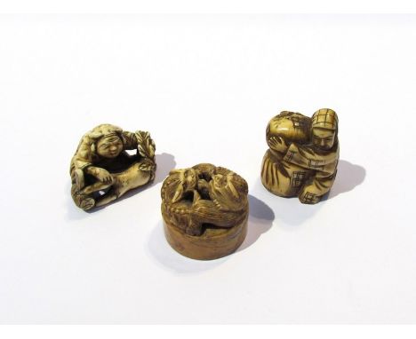 Circa 1900 two carved ivory Netsuke and a pot lid (3) 