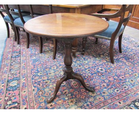 A George III mahogany tripod table with tilt top, 57cm diameter