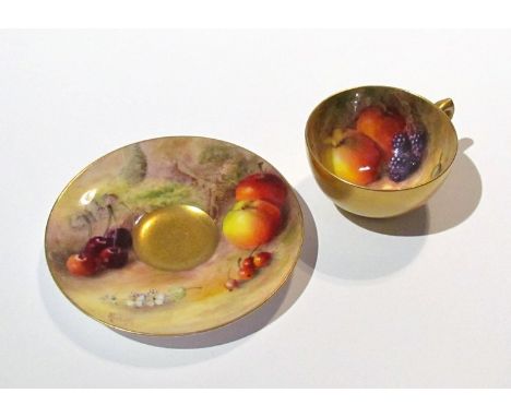 A Royal Worcester miniature cup and saucer, gilded exterior with hand painted fruit design, signed Rickells 