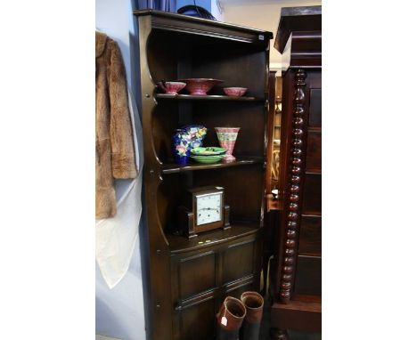 An Ercol corner cabinet