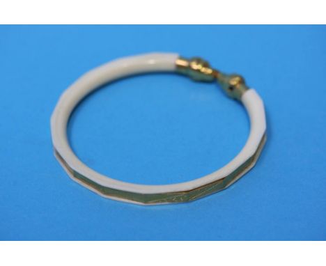 A gold metal mounted ivory bangle