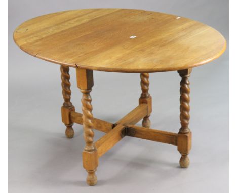 A mid-20th century light oak oval gate-leg dining table on four barley-twist legs &amp; turned feet with plain stretchers, 36