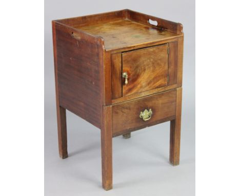 A Georgian mahogany tray-top night commode with a central cupboard enclosed by a panel door, above a frieze drawer, each with