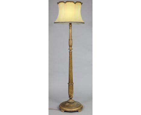 A late Victorian carved giltwood standard lamp on circular base, with shade, 184cm high x 43cm wide.