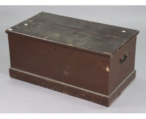 An early 20thC stained deal storage trunk with a hinged lift-lid, &amp; with wrought-iron side handles (split to top), 36” wi