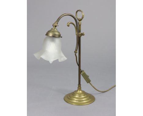 An Edwardian brass desk lamp with shaped glass shade, on adjustable column &amp; circular base, 17½” high.