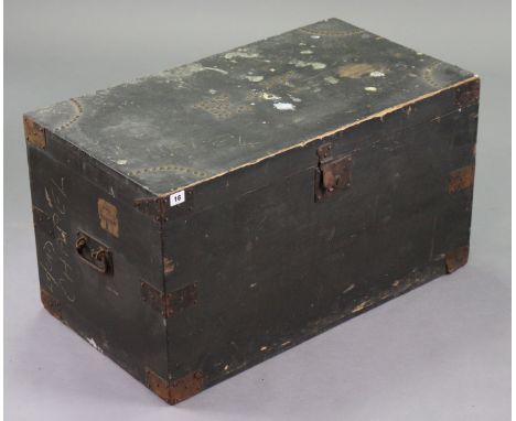A Late 19th/early 20th century brass-studded &amp; black painted deal travelling trunk with a hinged lift-lid, 32” wide x 17¼