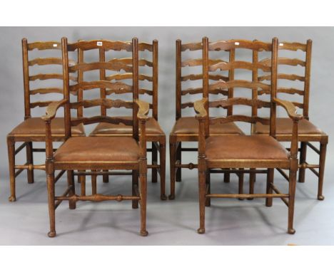 A set of six Lancashire-style oak ladder-back dining chairs (including a pair of carvers) each with a padded seat, &amp; on t