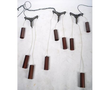 A matching set of three retro 20th Century style hanging ceiling light fixtures with each having triple cylindrical metal dro