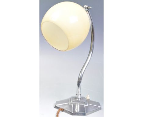 A retro vintage early 20th Century Art Deco chrome table lamp having a caramel glass lampshade raised on a curved tubular arm