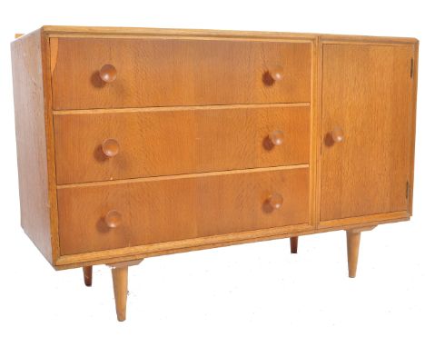 Meredew - A retro mid 20th Century light oak sideboard credenza having a small raised gallery back over a bank of three long 