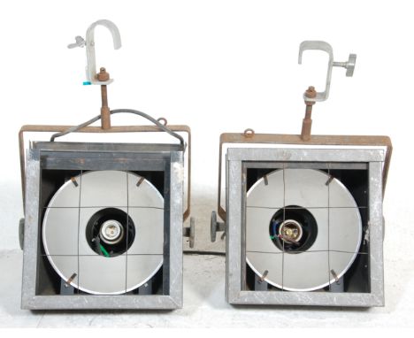 A set of retro vintage Strand theatre overhanging ceiling lighting lamps having metal case with internal lighting functions.