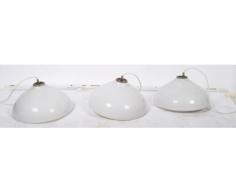 Three large white glass ceiling lights / lamps with mounting strip. The white frosted glass shades having a smaller inner sha