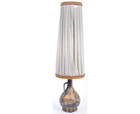 A large and impressive retro vintage 20th Century floor standing lamp comprising of a bulbous pottery lamp base with yellow a