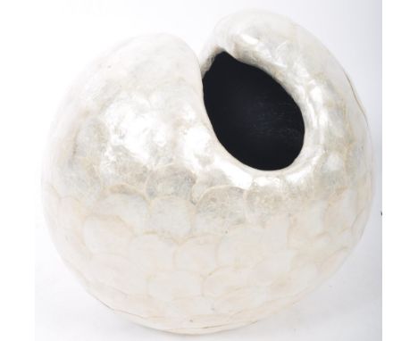 An unusual 20th Century large studio art sculpture depicting an ovoid shell decorated with faux mother of pearl panels. Hollo