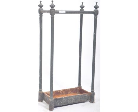 An early 20th Century industrial architecture wrought iron stick stand / umbrella stand having a six section top with finial 