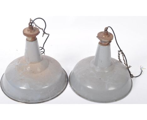 A matching pair of retro vintage 20th Century English industrial porcelain enamel pendant hanging lights having large UFO wid