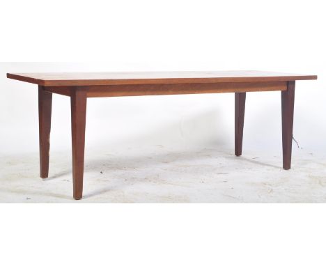 A retro vintage 1960's Danish influence teak wood coffee table of rectangular form. The side occasional coffee table raised o