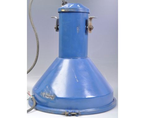 A large retro vintage dark blue industrial / factory flood light / lamp. the light having a large bulbous shade with clear pe