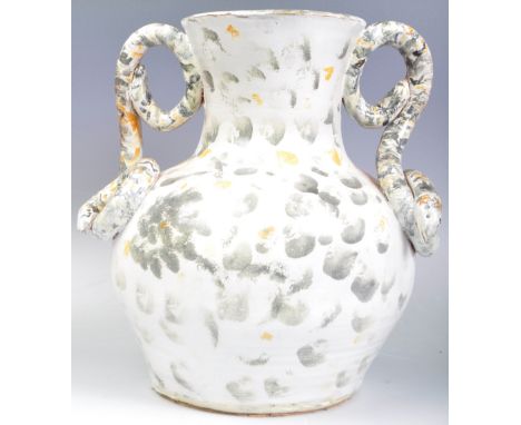 A retro vintage 1960's French studio art pottery vase of large size having moulded twin coiled snake handles White glaze with