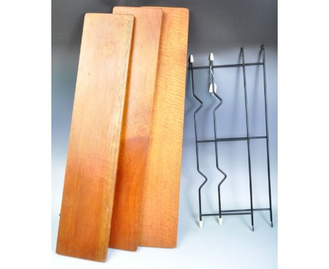A retro vintage 20th Century teak wood wall mounted set of shelves comprising of two ebonised metal uprights with white atomi