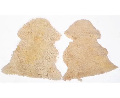 A pair of original vintage retro 1960's sheepskin floor carpet rugs, both constructed from 100% ivory wool on cloth backing. 