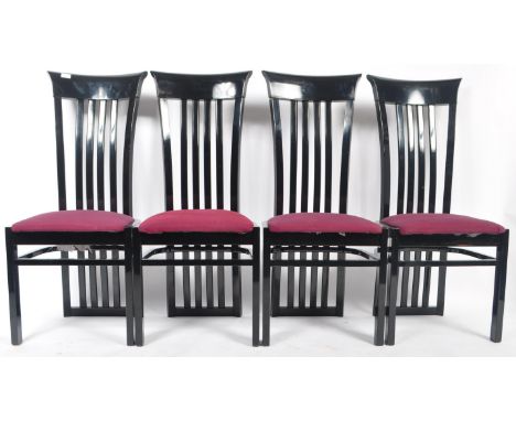 A set of four retro vintage 20th Century Italian designer dining chairs having a black lacquer paint finish. Tall slatted bac