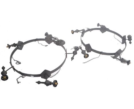 A large and impressive pair of antique style metal ceiling light fixtures / chandeliers of circular form having multiple orna
