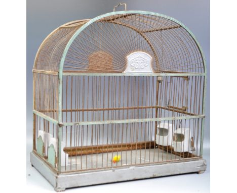 A retro vintage 20th Century four bird bird cage having a wire construction with metal base complete with four small porcelai
