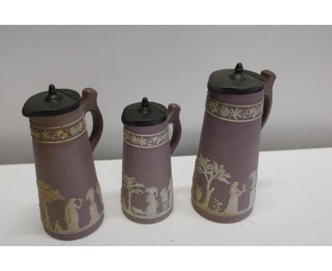 A set of three graduated Wedgewood lidded jugs - chip in one base ring