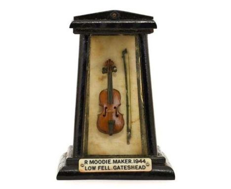 total length approx. 1 7/8" with bow in display case with celluloid windows and wood frame; with hand drawn diagram of measur