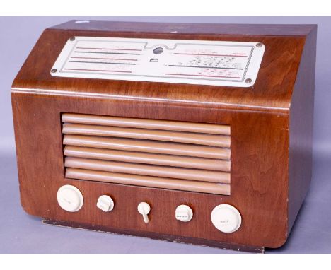 an HMV Type 5201 with raised dial and cream knobs; a Pilot three-band receiver with curved fretted wood case and magic eye tu