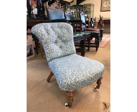 Victorian low upholstered nursing chair with original ceramic and brass castors