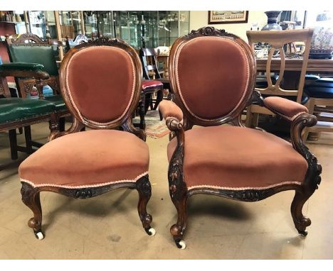 Pair of 'His and Hers' Victorian bedroom chairs with carved detailing and ceramic castors