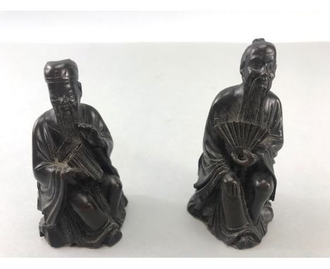 Two Chinese /eastern Bronze seated figurines, one with fan the other with pipes approx 8cm tall