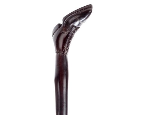 *Walking Cane. An Edwardian walking stick carved from a single piece of rosewood,  the handle carved as a boot with detailed 