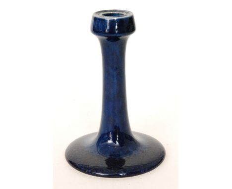 An early 20th Century Ruskin Pottery souffle glaze candlestick, the whole glazed in blue, impressed mark and dated 1910, heig