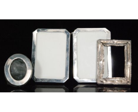 A pair of hallmarked silver canted rectangular easel photograph frames, heights 10cm, Birmingham 1920, Baldwin & Marriott, wi