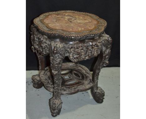 A late 19th to early 20th Century Oriental Export hardwood jardiniere stand with a rouge marble inset top within a foliate re