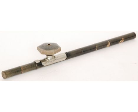 A Chinese opium pipe with stag horn stem mounted with a carved jade symbol and octagonal grey pottery bowl, length 56cm