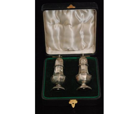 A cased set of hallmarked silver pepper pots, each of octagonal baluster form with pierced pull off cover, Birmingham 1898, J