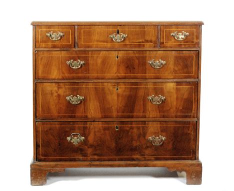 A Georgian mahogany chest of six drawers, with walnut veneered top and cross banded borders, all above bracket feet, some lat