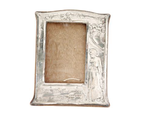 An Edwardian hallmarked silver rectangular easel photograph frame embossed with a standing woman holding a bucket beneath and