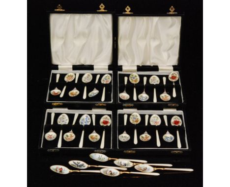 Four cased sets of six guilloche enamelled teaspoons, each with floral designs of roses, pansies, forget me nots etc. against