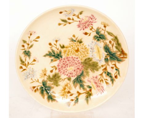 An early 20th Century Zsolnay Pecs charger decorated with sprays of flowers against a cream ground, impressed and printed mar