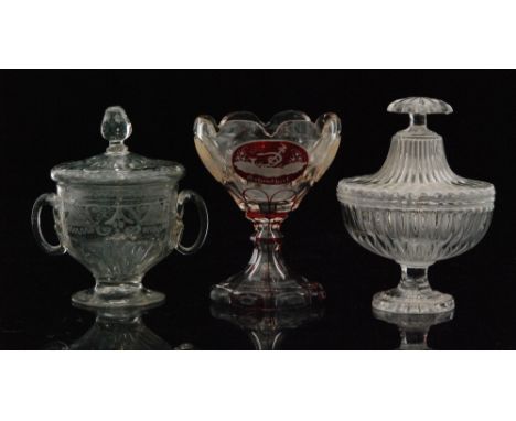 An 18th Century glass lidded twin handled pedestal bowl with an engraved border above basal moulding rising to a moulded lid 